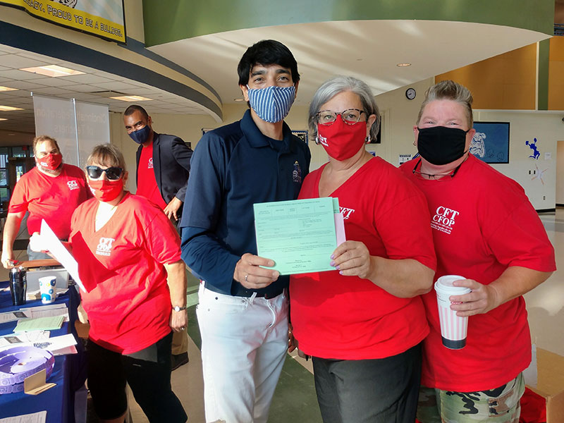 Masked members of CFT together in a school